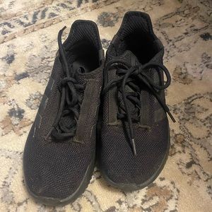 Black on black Adidas tennis shoes